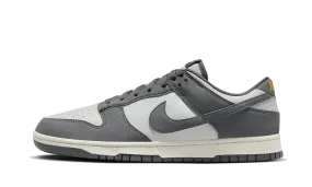 Dunk Low Next Nature Iron Grey Lightning running on snow shoes