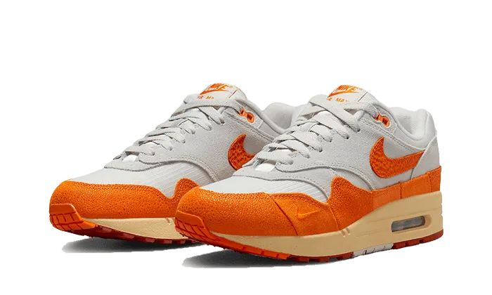 amateur running shoes running on a gravel road Air Max 1 Magma Orange