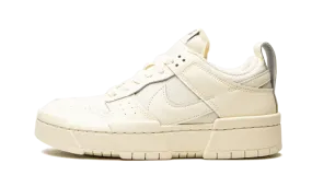 Dunk Low Disrupt Coconut Milk running in a tram station area shoes Recommended